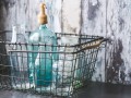 kaboompics.com_Vintage empty bottles in metal basket